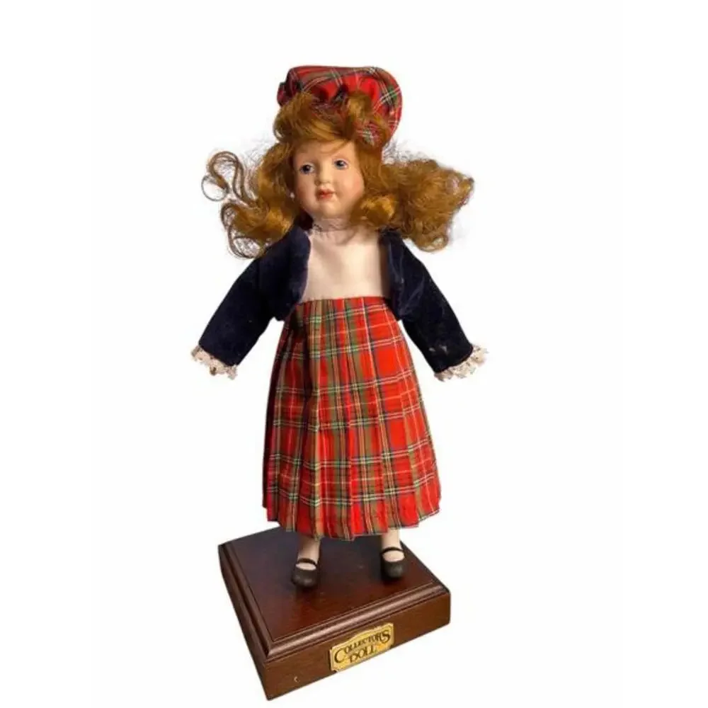 Doll porcelain Danbury Mint.  The doll is dressed in traditional Scottish attire
